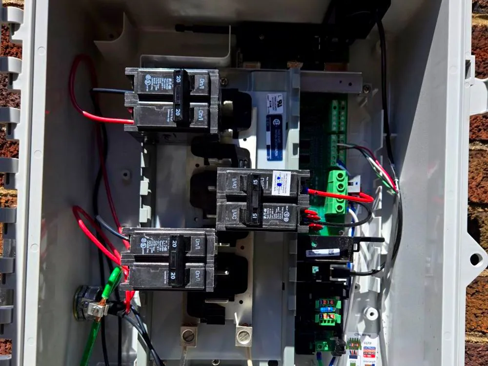 AC combiner panel with breakers and labelled circuits feeding a dedicated load