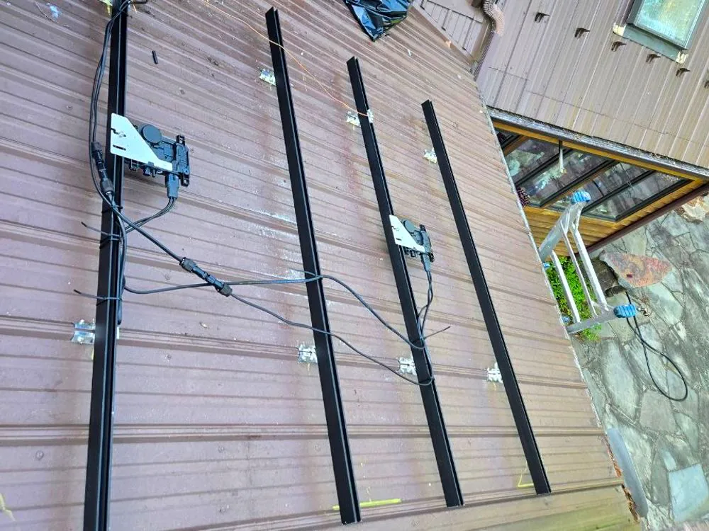 Mounting rails being installed on a metal roof at a Western Pennsylvania property
